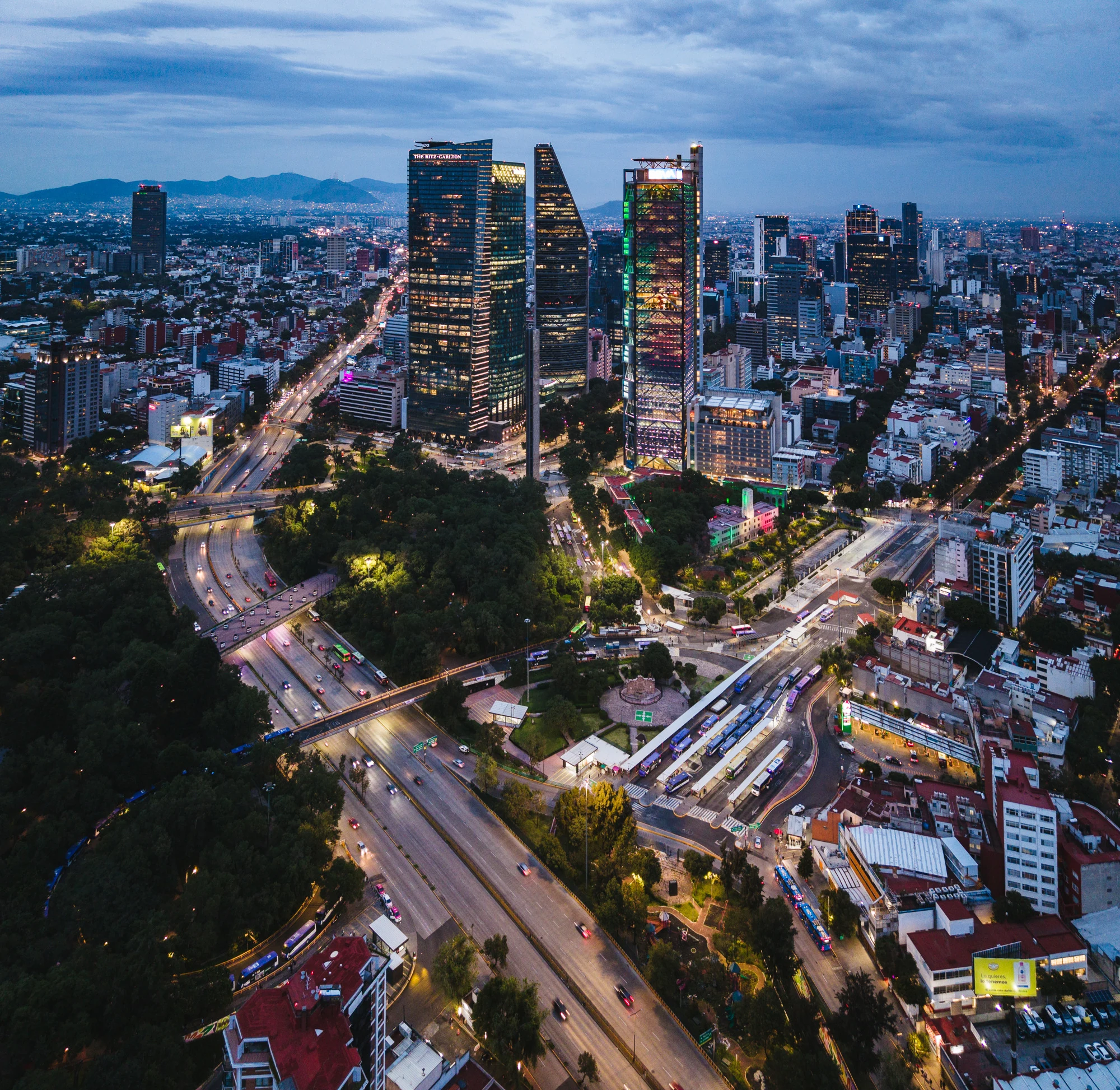 Mexico City skyline and illuminated streets at dusk
